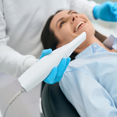 Dentist preparing to scan a patient's teeth