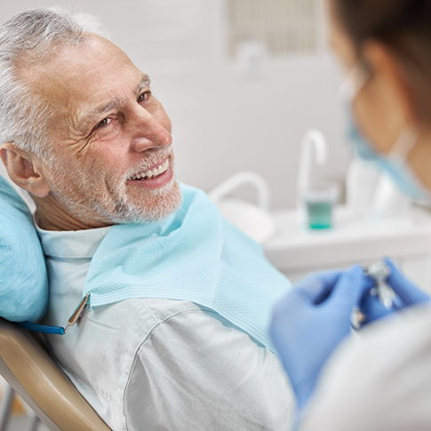 Smiling senior man in the dental chair