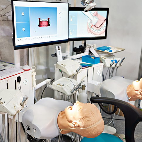 Row of practice treatment stations in a dental training facility