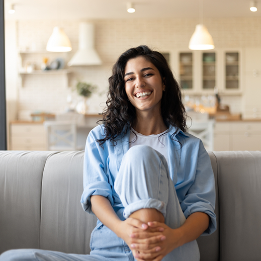 Young woman smiling on her couch