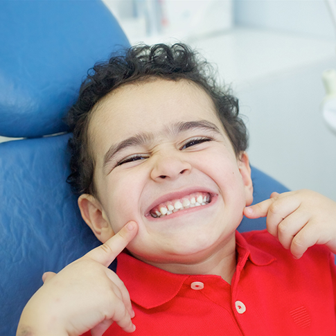 Young boy grinning in the dental chair