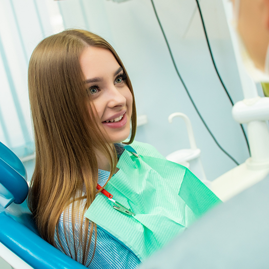 Young woman listening to her dentist