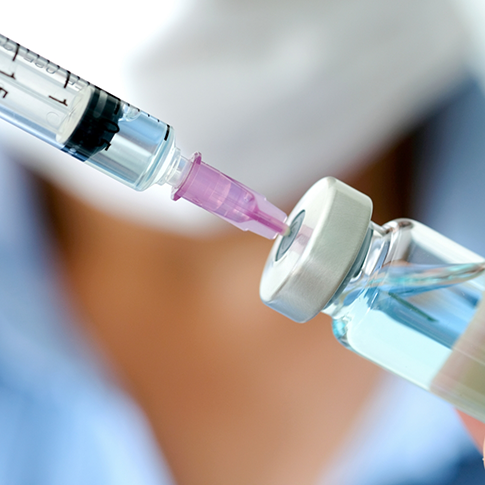 Drawing a syringe of clear liquid